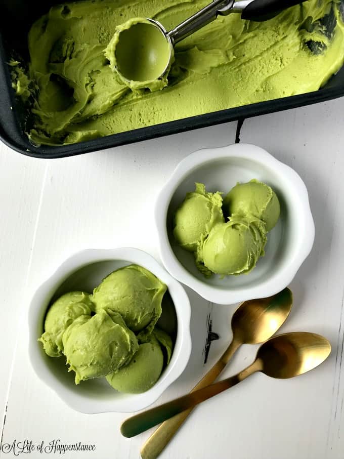Two white serving dishes filled with avocado mint ice cream. 