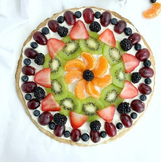 The fruit pizza on a white table.