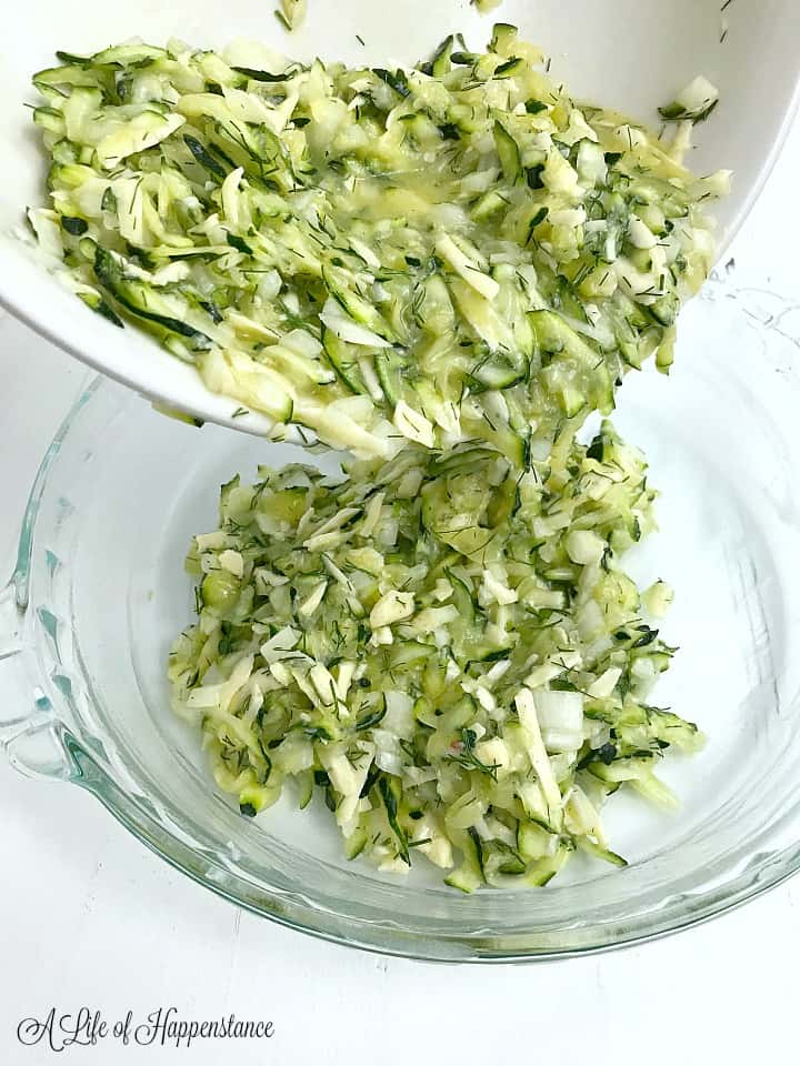 Pouring the zucchini mixture into a glass pie dish. 