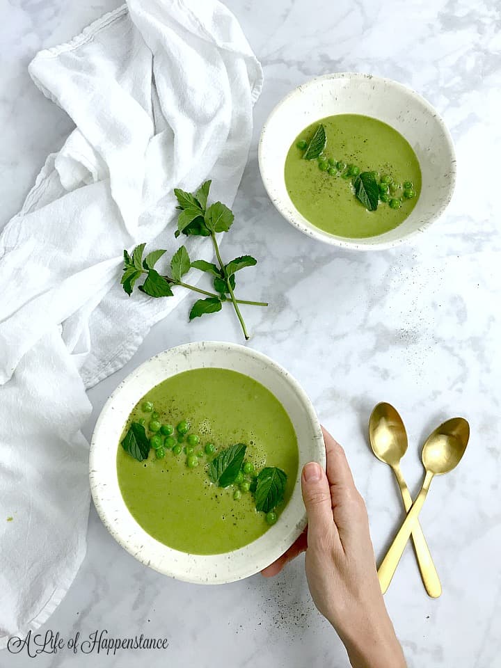 Two bowls filled with mint pea soup