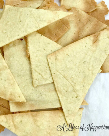 Paleo tortilla chips on white parchment paper.