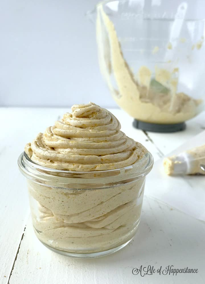 The pumpkin buttercream piped into a small glass container. 
