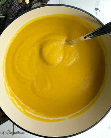 A large pot filled with the easy butternut squash apple soup recipe.
