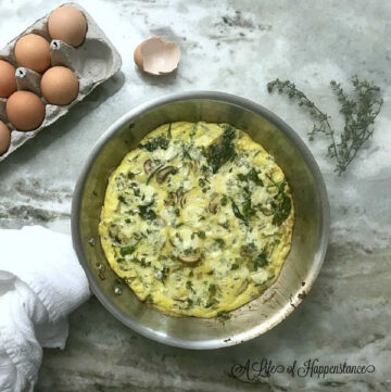 The spinach mushroom frittata in a frying pan.