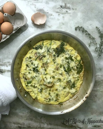 The spinach mushroom frittata in a frying pan.