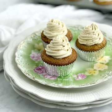 Three almond flour vanilla cupcakes on a vintage flower plate.