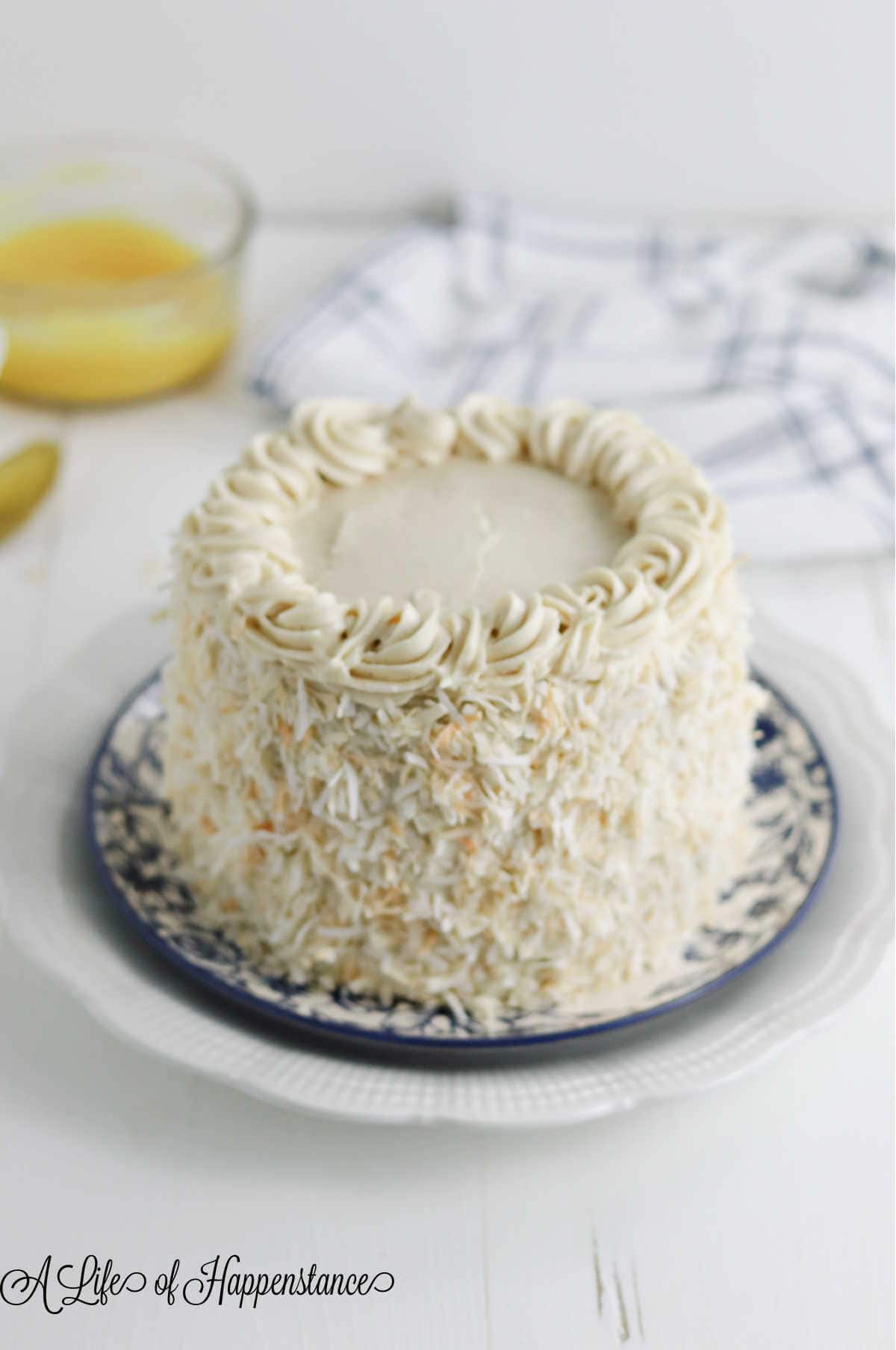 The almond flour coconut cake on a blue and white plate.