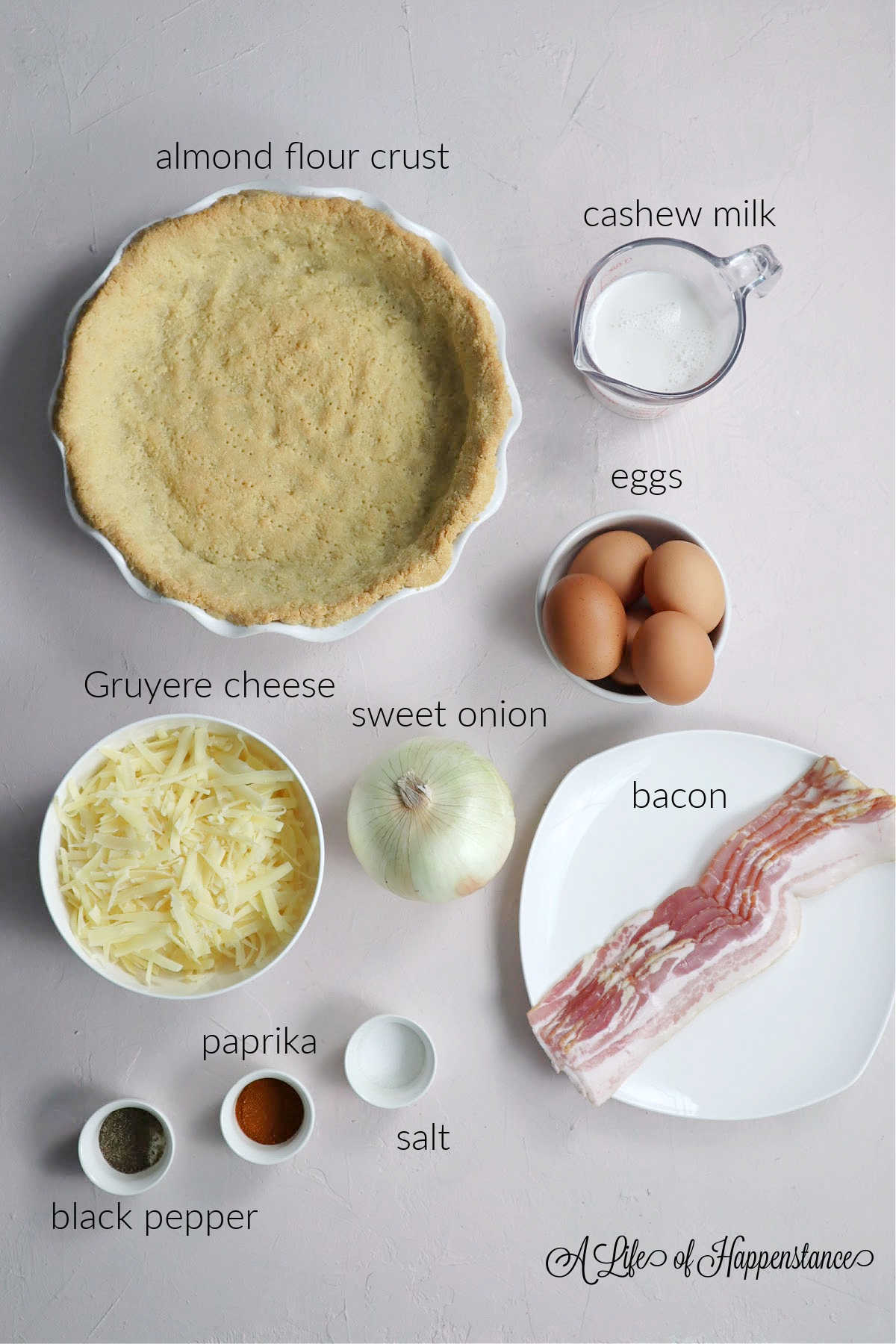 Ingredients for the quiche on a pink table.
